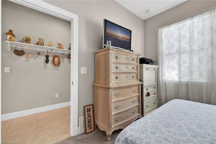 Bedroom with tile patterned floors and baseboards