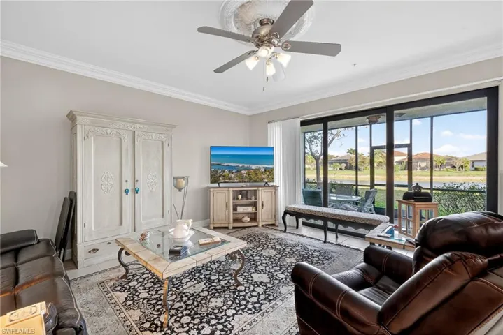 Living room featuring crown molding and ceiling fan