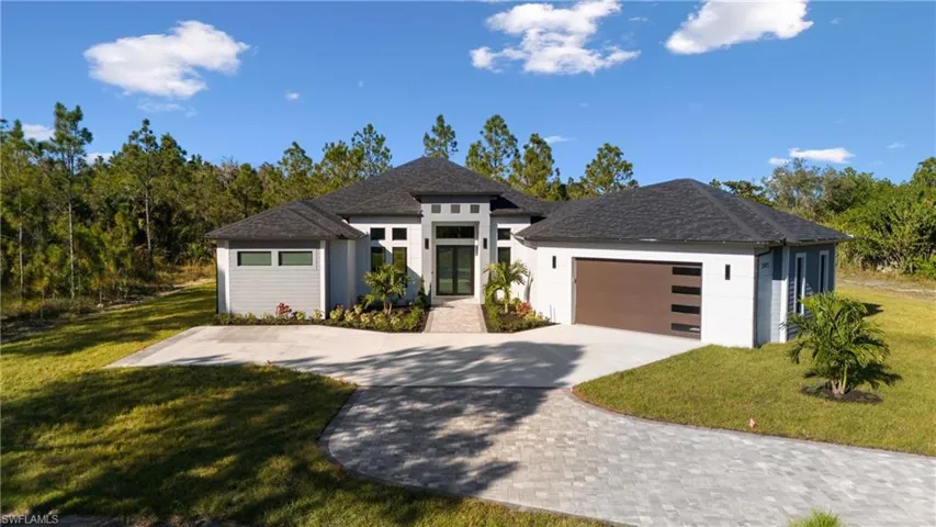 View of front of house with a front yard and a garage