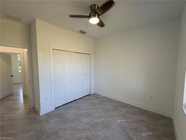 Unfurnished bedroom featuring a closet and a ceiling fan
