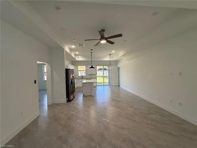 Unfurnished living room with recessed lighting, a ceiling fan, and concrete flooring