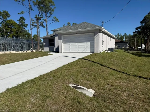 View of property exterior with driveway, stucco siding, a garage, and a shingled roof