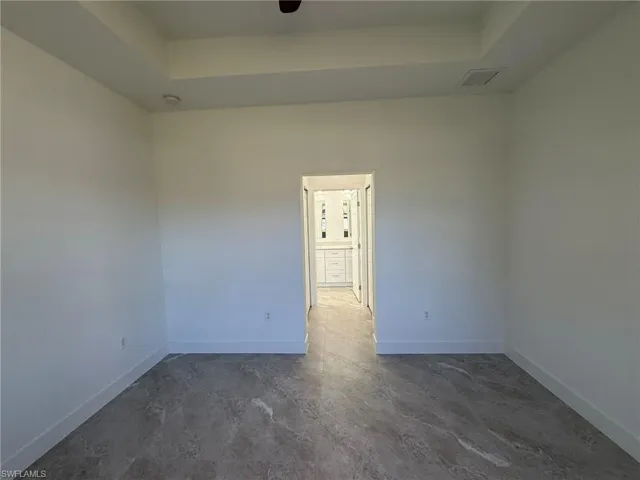 Empty room featuring a raised ceiling