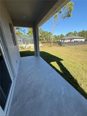 Fenced backyard with a patio