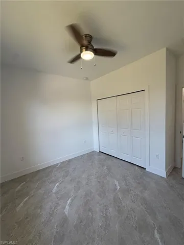 Unfurnished bedroom with a closet and ceiling fan