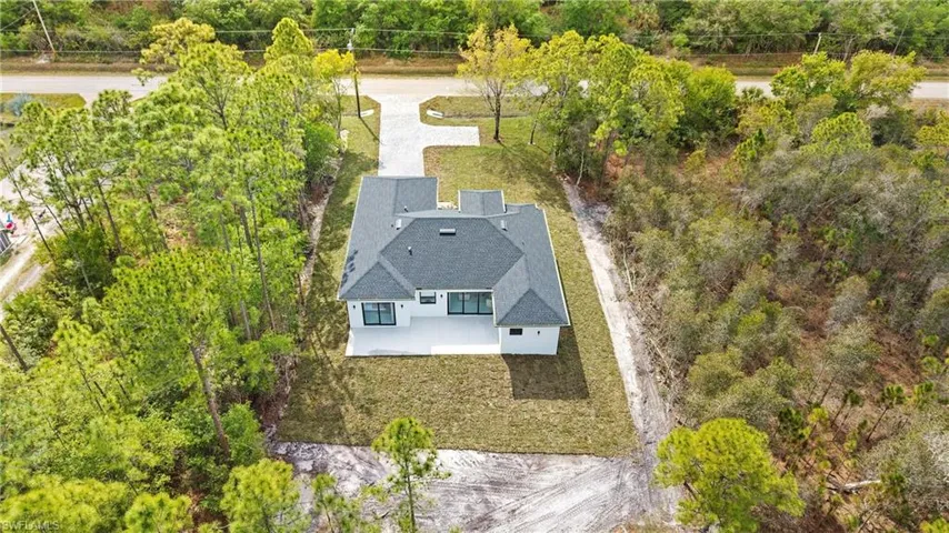 View from above of property with a tree filled landscape