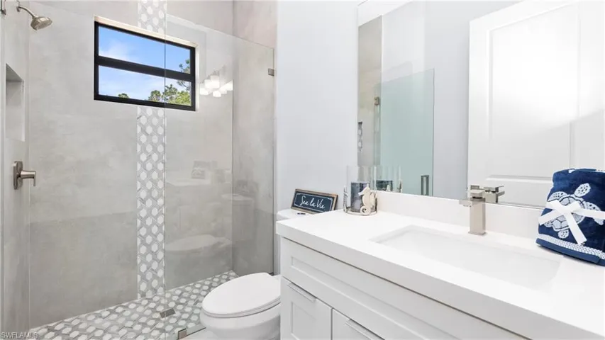 Full bath with vanity and tiled shower