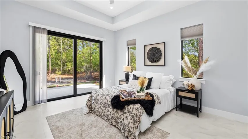 Bedroom with access to outside and ceiling fan