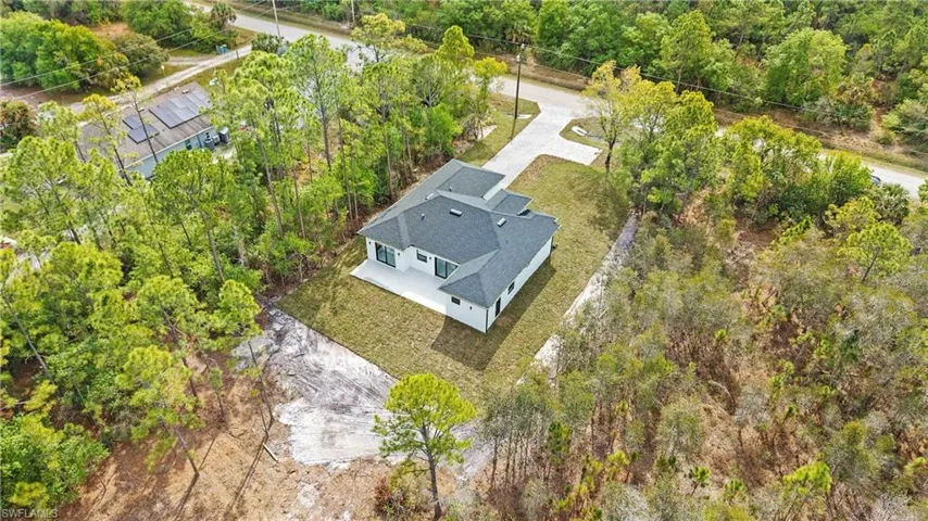 View from above of property with a tree filled landscape