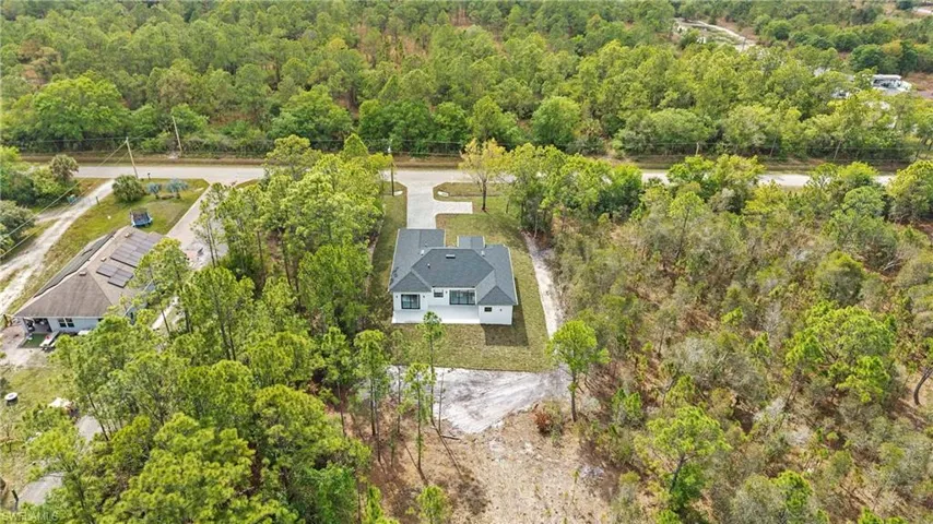 View of subject property featuring a forest