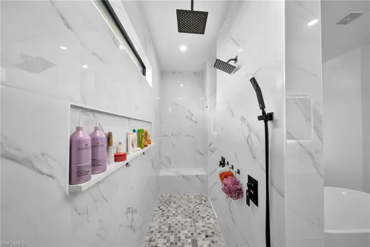 Bathroom featuring a marble finish shower