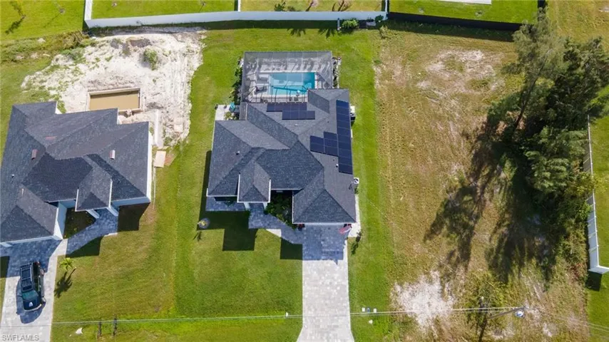 Aerial view of property and surrounding area with a pool area