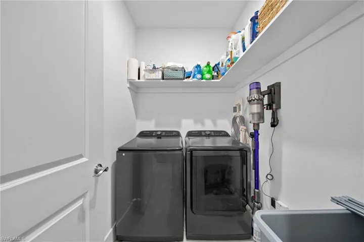 Laundry room with washing machine and clothes dryer