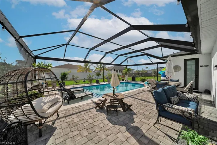 View of patio featuring an outdoor pool, an outdoor hangout area, and a lanai