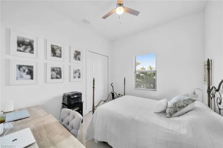 Bedroom featuring ceiling fan and a closet