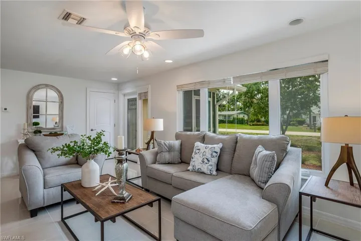 Living area featuring ceiling fan, recessed lighting, and tile patterned floors