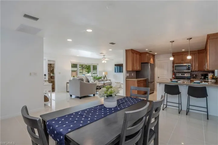Dining space with light tile patterned floors, recessed lighting, and a ceiling fan