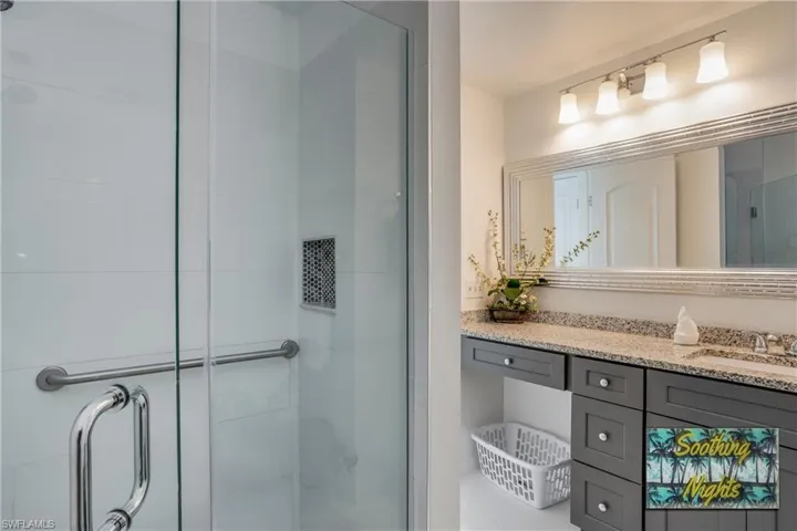 Full bathroom featuring vanity and a shower stall