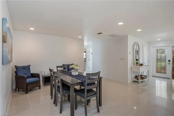 Dining area featuring light tile patterned floors and recessed lighting