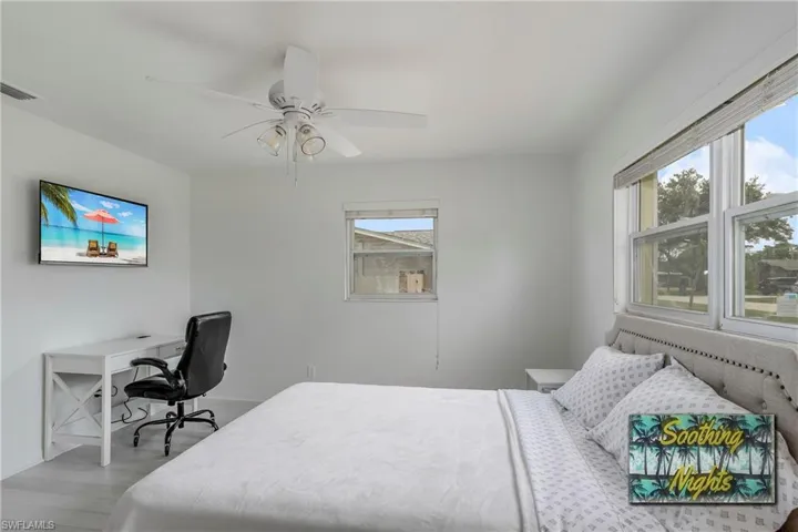 Bedroom with a desk and ceiling fan