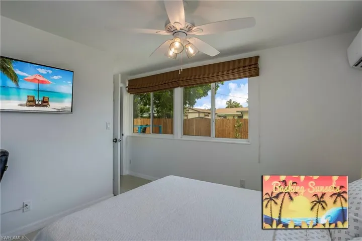 Bedroom with a ceiling fan and baseboards