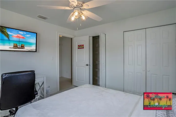 Bedroom featuring ceiling fan, a closet, and a desk