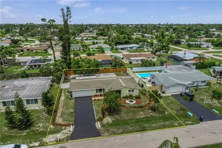 Aerial perspective of suburban area featuring property boundaries highlighted