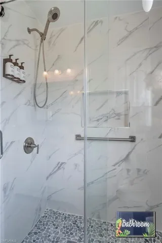 Bathroom featuring a marble finish shower