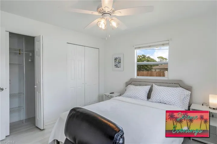 Bedroom with two closets, light wood-type flooring, and ceiling fan