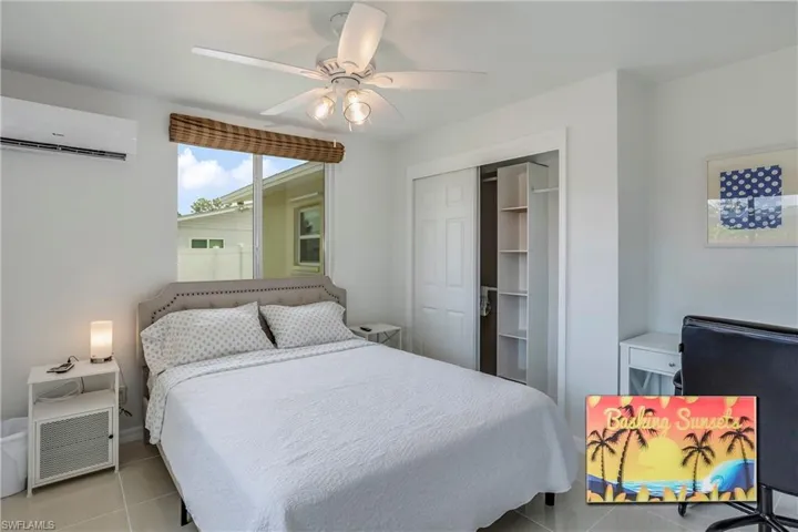 Tiled bedroom with a mini split for heating / cooling, a closet, and ceiling fan