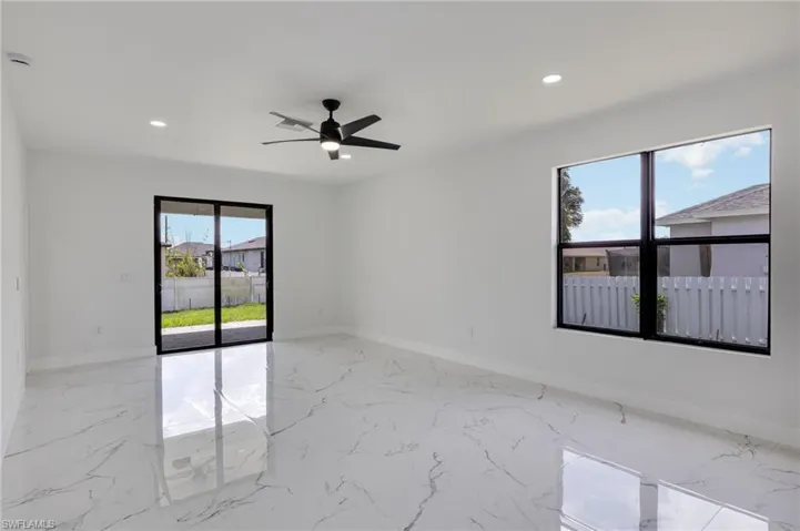 Empty room with light marble finish floors, recessed lighting, and a ceiling fan