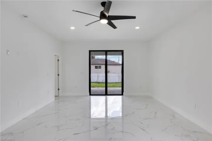 Spare room featuring light marble finish flooring, ceiling fan, and recessed lighting