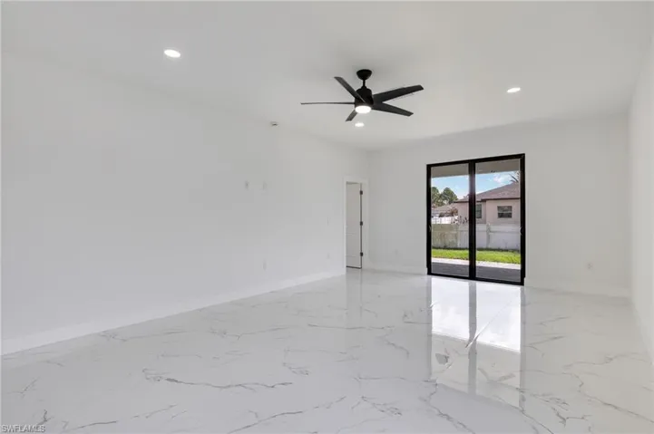 Spare room with ceiling fan, recessed lighting, and light marble finish floors