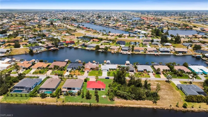 Aerial view of residential area featuring a large body of water