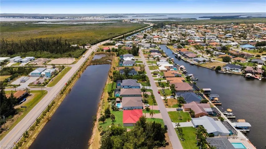 Aerial overview of property's location with nearby suburban area and a nearby body of water