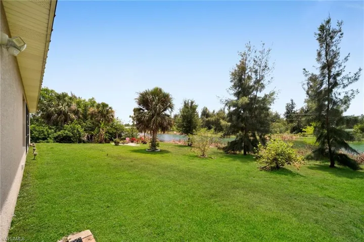View of green lawn featuring a water view