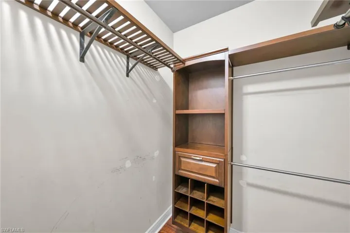 Walk in closet featuring wood finished floors