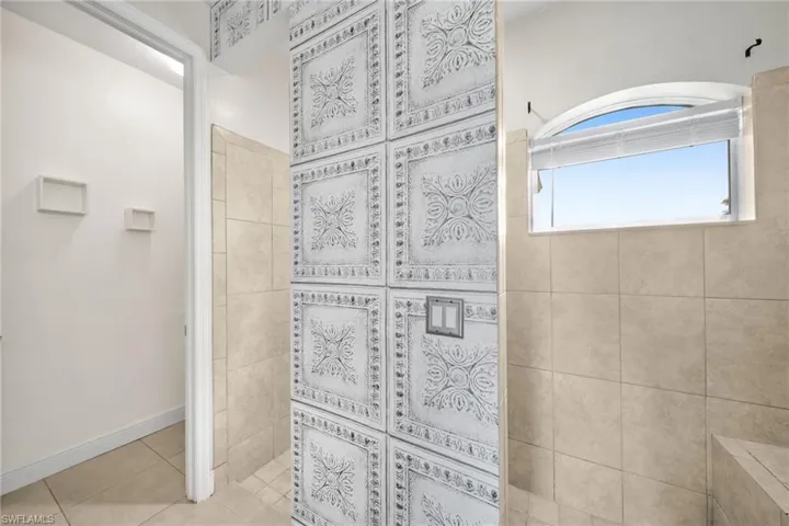 Full bath with a walk in shower and tile patterned floors