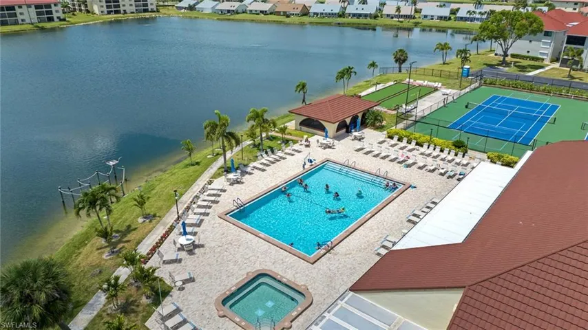 LOOK at this pool area and hot tub with pickleball courts in the background