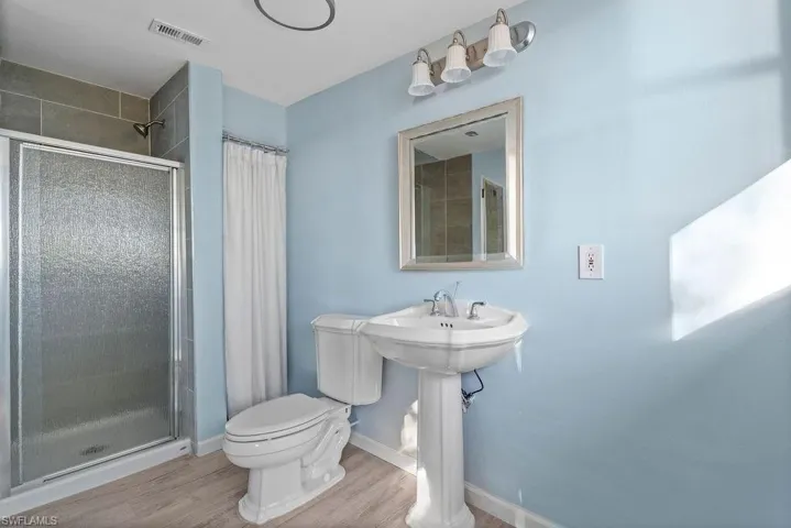 Bathroom off of the Den. Mirror and curtain added virtually.