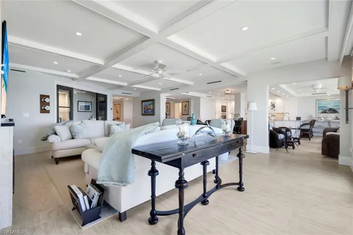 Living area featuring ceiling fan, coffered ceiling, beam ceiling, recessed lighting, and light wood-style flooring