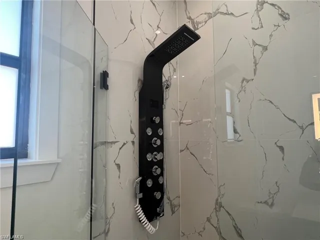 Bathroom view of a marble finish shower