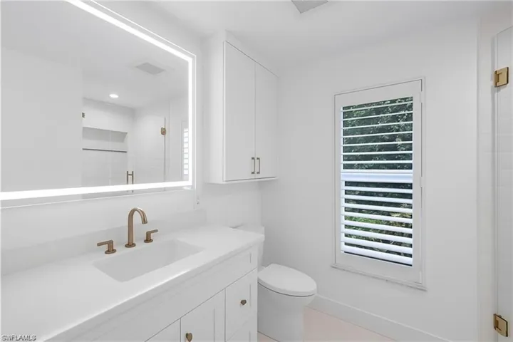 Full bathroom with vanity, a shower stall, and light tile patterned flooring