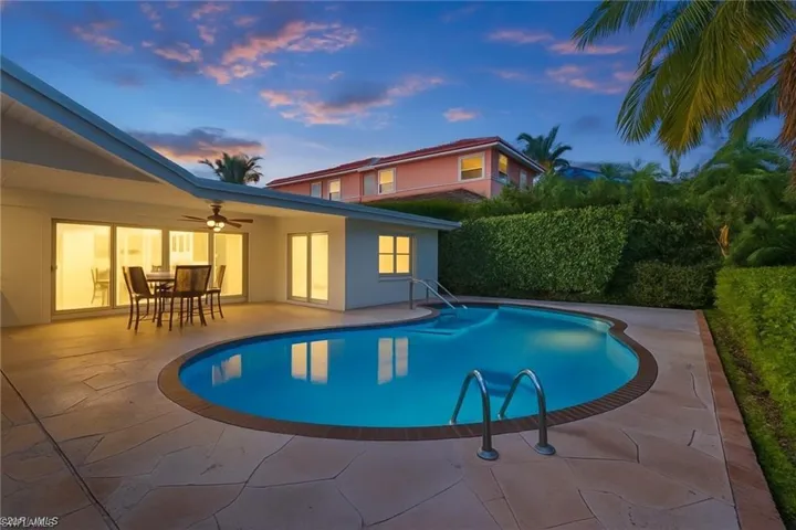 View of swimming pool with a ceiling fan, a patio area, and outdoor dining area