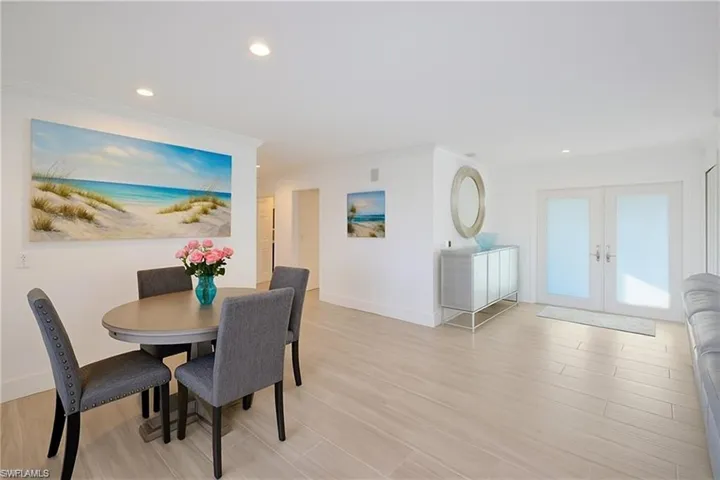 Dining room featuring french doors, recessed lighting, light wood-style flooring, and ornamental molding