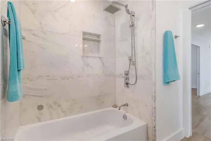Bathroom with shower / bath combination and recessed lighting