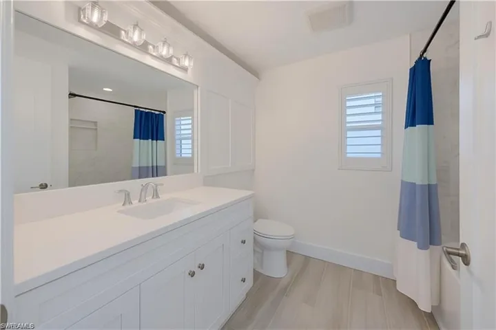 Full bath featuring vanity and a shower with curtain