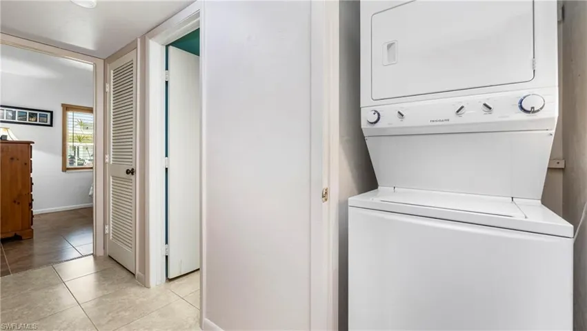 Laundry room featuring a stacked washer and dryer