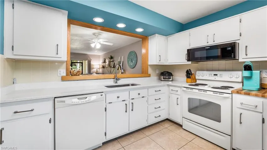 Kitchen with white appliances.