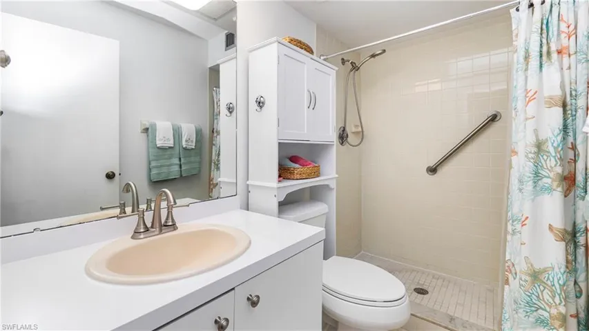 Bathroom featuring vanity and a stall shower